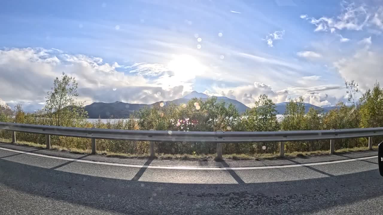 Scenic drive through the rainy mountain roads near Tromsø, Norway, captured from a GoPro Hero 12 attached to a car window. The footage showcases the dramatic natural beauty of Northern Norway.