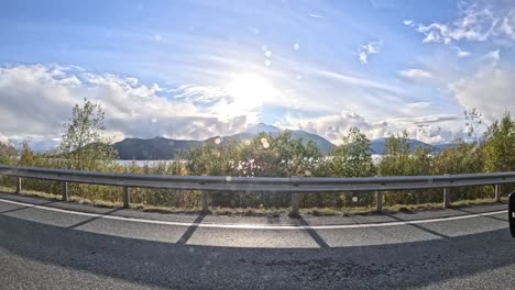 scenic drive through the rainy mountain roads near tromsø, norway, captured from a gopro hero 12 attached to a car window. the footage showcases the dramatic natural beauty of northern norway.