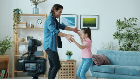 father and daughter dancing at home