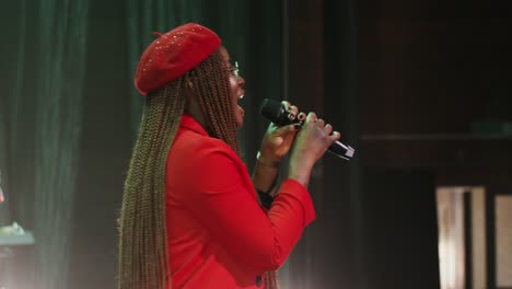 woman singing on stage