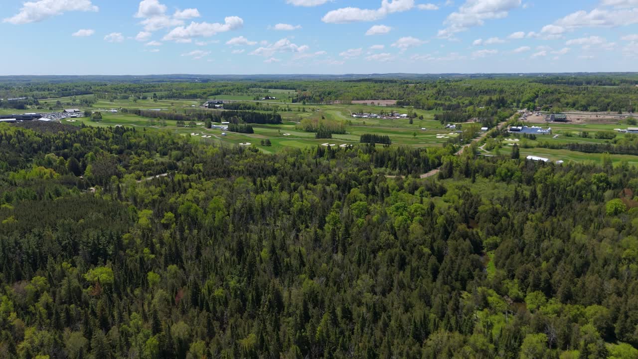 Rising Aerial Shot Of A Forest Surrounding A Professional Tour Golf Course In Caledon, Canada.