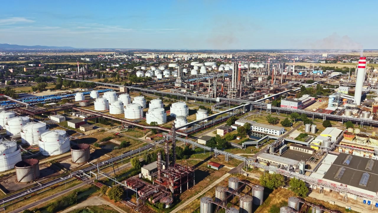 Industrial area with oil storage tanks and processing facilities in daytime