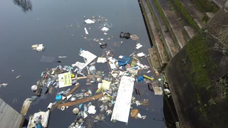 rubbish floating in disused dock woolwich london uk