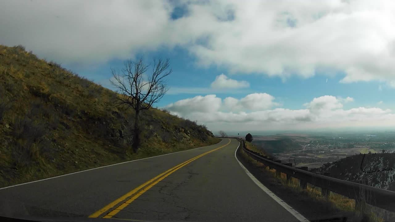 Hyperlapse of Driving down a cliff side Road in the Rocky Mountains on a cold sunny morning, vehicle time lapse