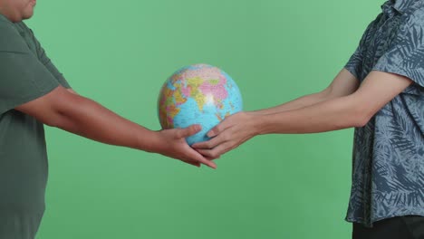 two people holding a globe