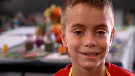portrait of schoolboy standing in apron 4k