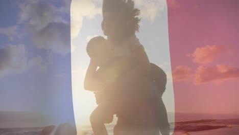 animation of flag of france over african american couple embracing at beach