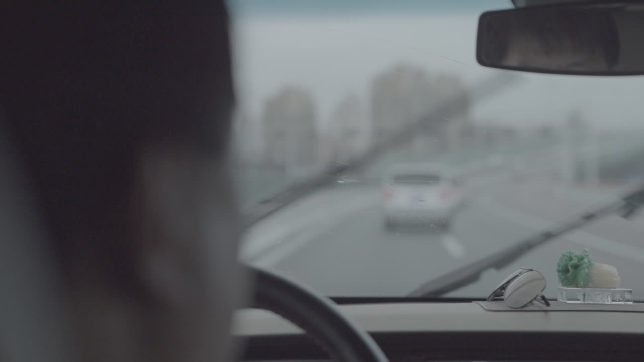 Shot Of Man Driving On Road Rainy Day