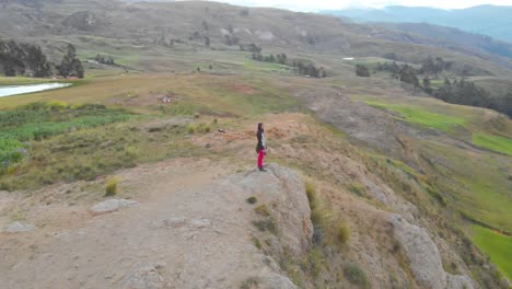 Man alone in front of the peruvian andes in huaraz city lake wilcacocha, drone around fly aerial shoot.