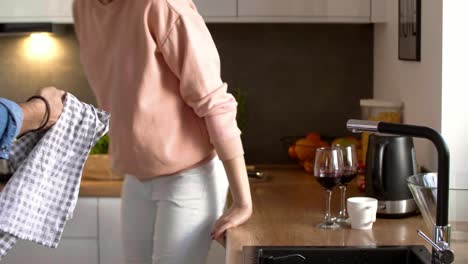 Young-couple-drinking-red-wine-in-the-kitchen