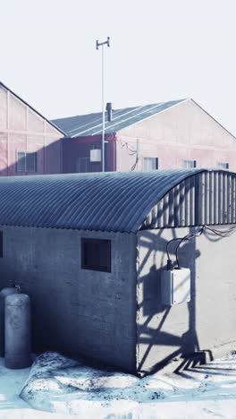 concrete outbuilding in a snowy industrial area