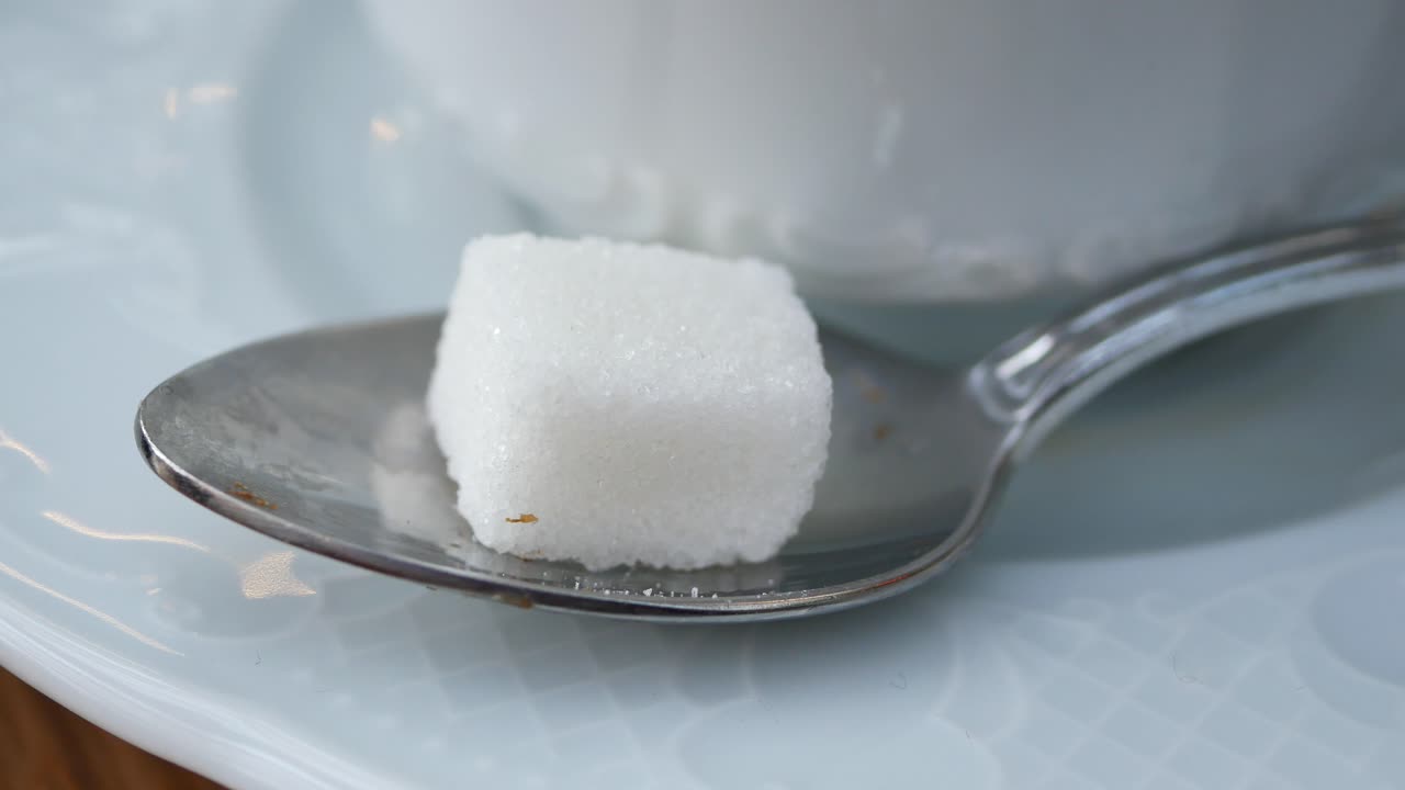 A sugar cube on a spoon