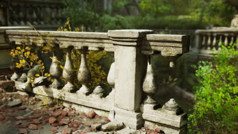 close up of a ruined stone balcony with plants growing around it