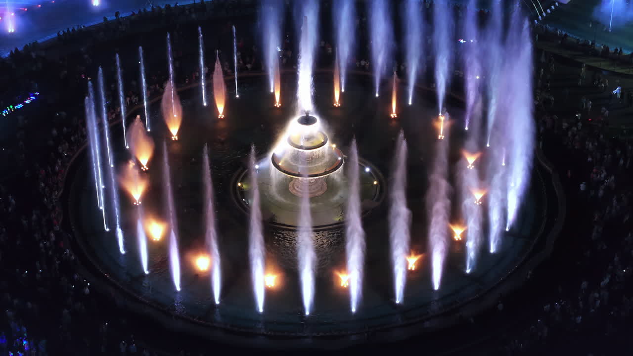 Aerial drone view of the illuminated Bucharest fountains in Romania, at night
