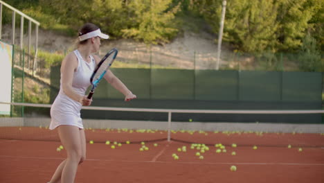 Primer-Plano-De-Una-Mujer-Sosteniendo-Una-Raqueta-De-Tenis-Con-Ambas-Manos-Para-Enderezar-El-Golpe.-Primer-Plano-De-Una-Joven-Atractiva-Jugando-Tenis-En-La-Cancha-De-Tenis.-Jugador-Sosteniendo-Traje.-Camara-Lenta