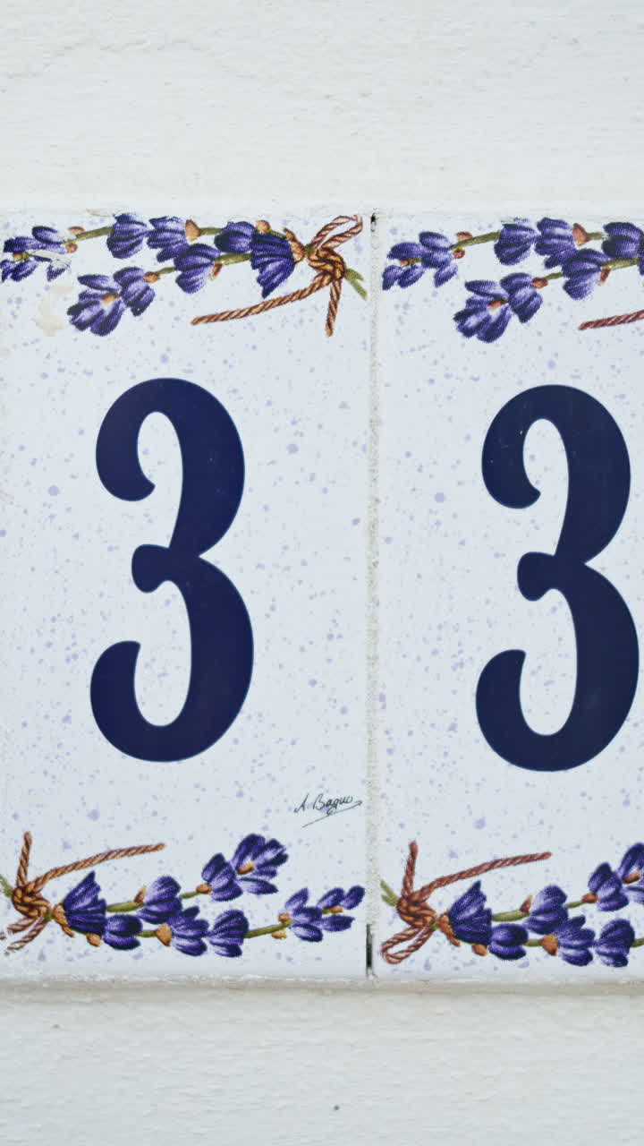 Close up of the number 33 on a white house. Vertical