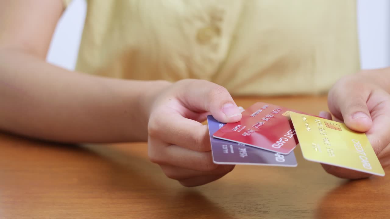 A person showcases multiple cards highlighting diverse payment options and financial decision-making in daily life