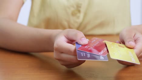 a person showcases multiple cards highlighting diverse payment options and financial decision-making in daily life