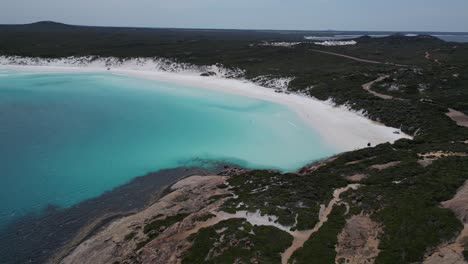 Aerial-establishing-shot-of-Wharton-Beach-with-crystal-clear-turquoise-bay-water-in-Western-Australia