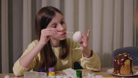 girl painting easter egg