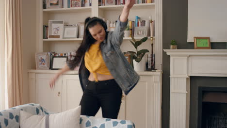 funny young woman dancing wearing headphones listening to music having fun teen girl celebrating with cool dance moves at home enjoying freedom on weekend 4k