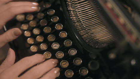 top down shot of woman's hands typing on vintage typewriter - slide across keys