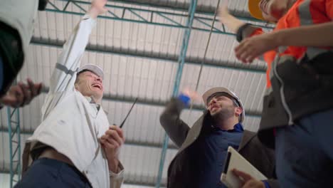 bottom view of multi-ethnic businesspeople putting their hands on top of each other. stack of hands showing unity and teamwork. successful meeting. business and teamwork or teambuilding concept.