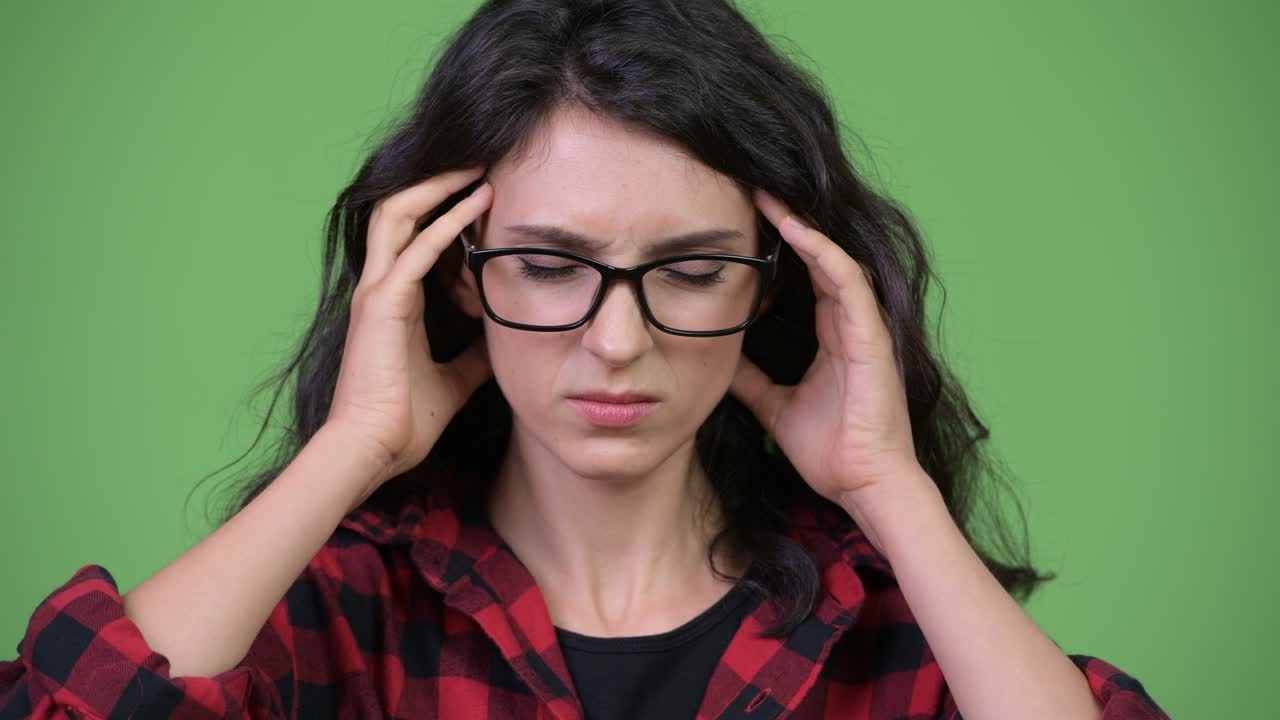 Young beautiful businesswoman having headache