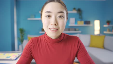 Young-Asian-woman-giving-motivational-speech-with-smile-to-camera.