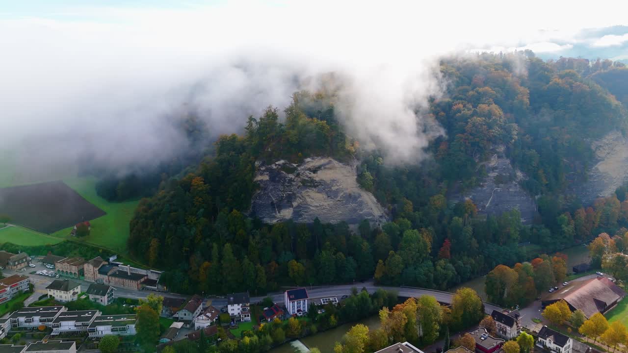 Aerial View of a Misty Autumn Village in Switzerland