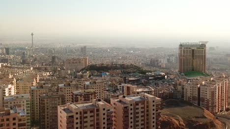 Drone-landing-view-of-Tehran-Iran-city-landscape-wide-horizon-Iconic-Milad-tower-city-center-air-pollution-in-a-day-time-in-middle-east-people-living-local-traditional-in-apartment-but-the-government