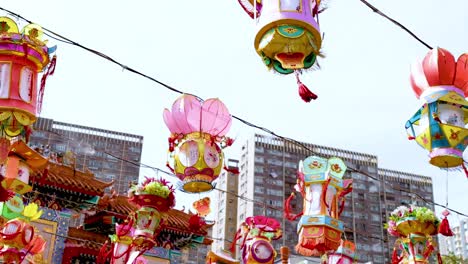colorful lanterns hanging in front of a cityscape, showcasing a blend of tradition and modernity.