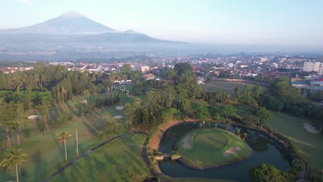 the view of the golf course in the morning is mount sumbing