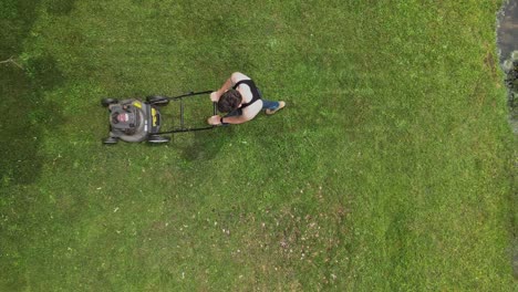 Overhead-View-Of-A-Person-Cutting-Grass-Using-Lawnmower-Machine