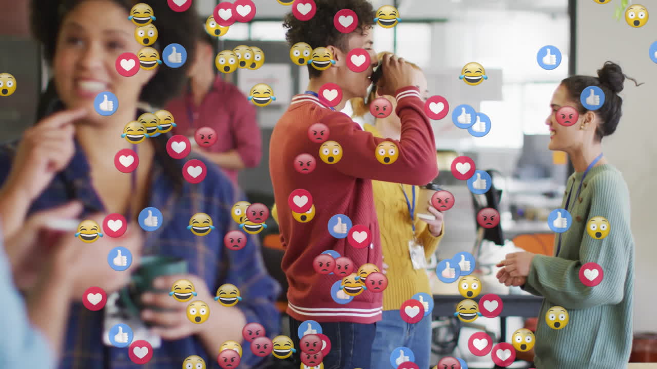 Colleagues drinking coffee and chatting in open-plan office showing floating emojis for marketing