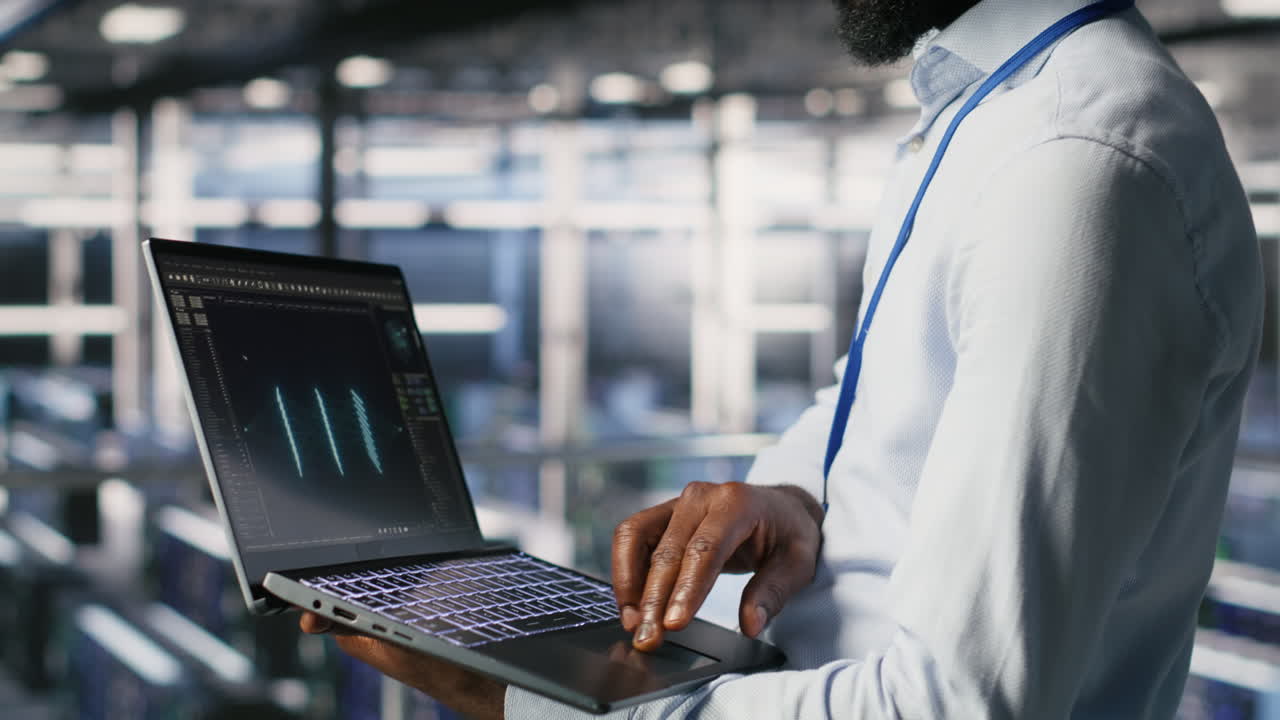 Engineers in data center reviewing large language model visualizations on laptop
