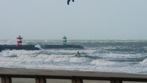 kiteboarding in a stormy ocean with lighthouses