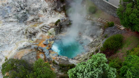 aerial drone shot of furnas volcanic natural geothermal hot springs in sao miguel in the azores islands, atlantic ocean - portugal