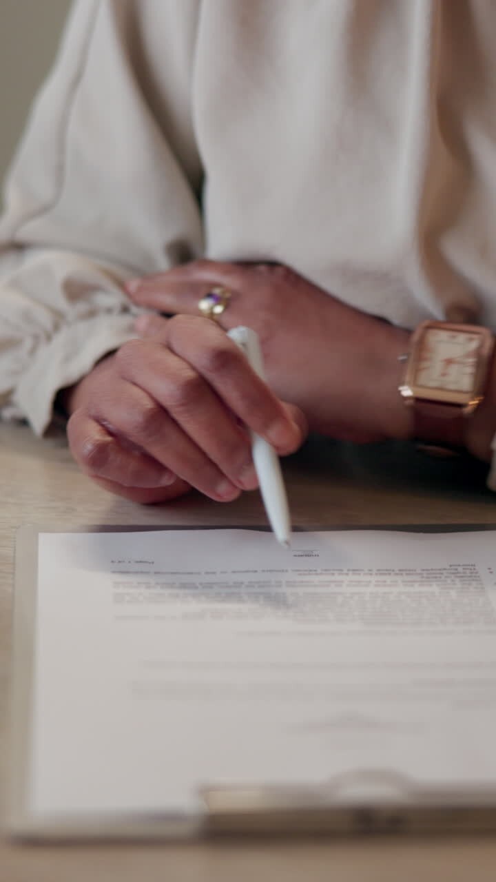 Woman signing a document at a desk