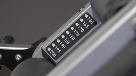 measurements to adjust the size of the fitness machine in an indoor gym