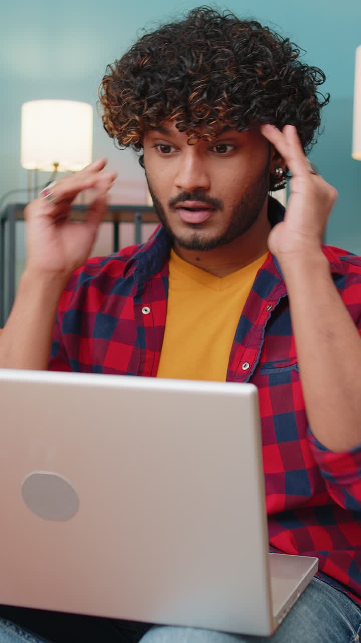 Tired indian man freelancer use laptop suffering from headache problem tension and migraine stress