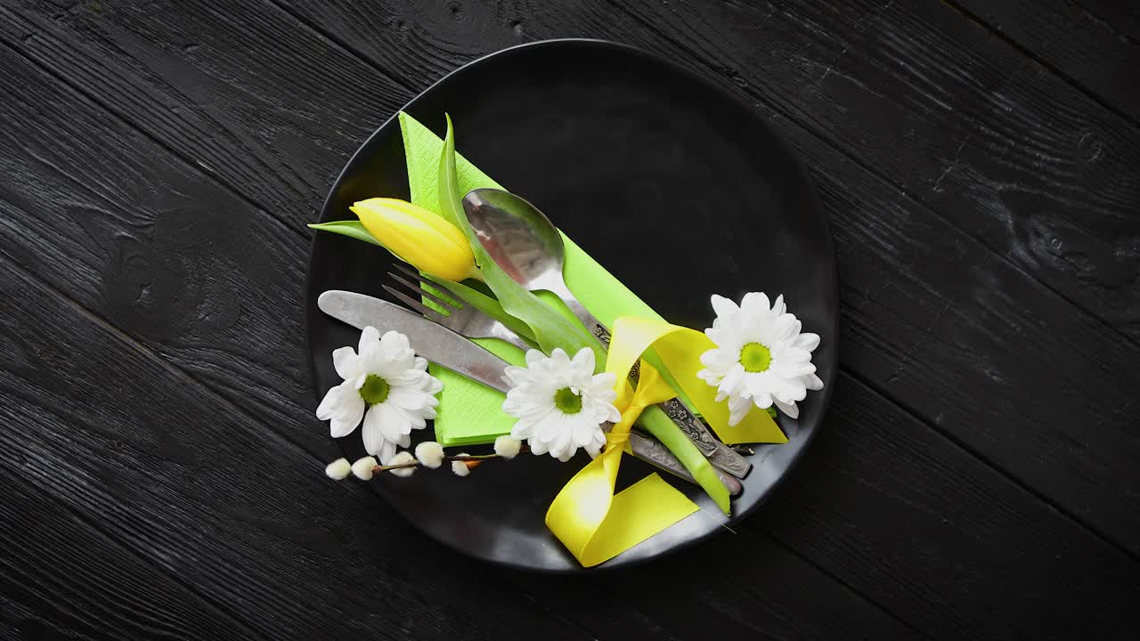 Easter spring table dishware composition with yellow tulip flower