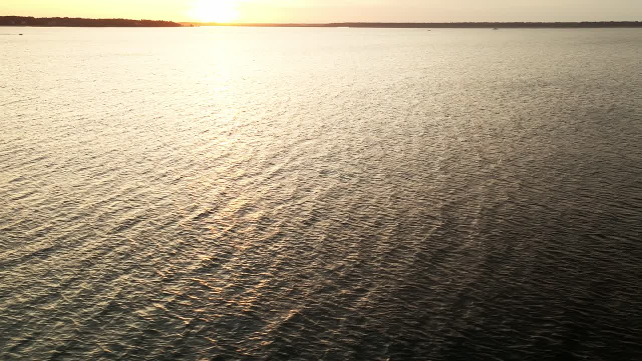 Soothing sunset over tranquil ocean horizon with soft reflections and no people in view