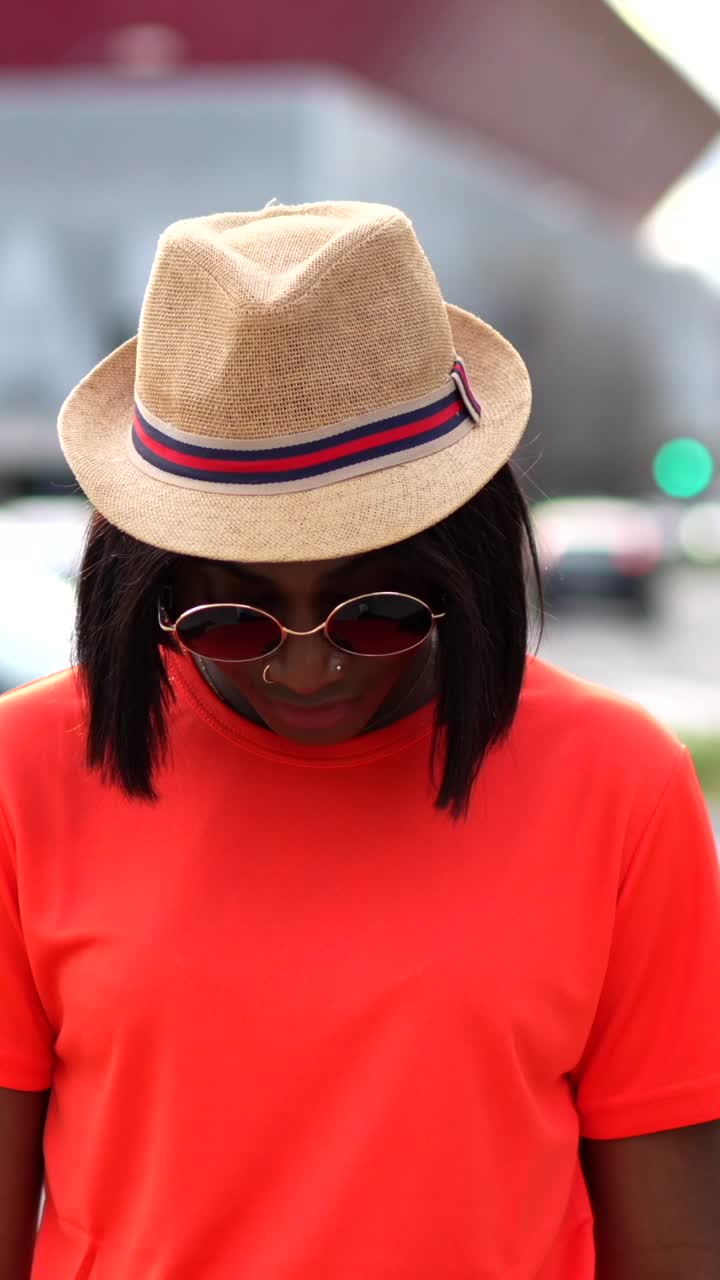 Portrait of a woman wearing sunglasses and a hat