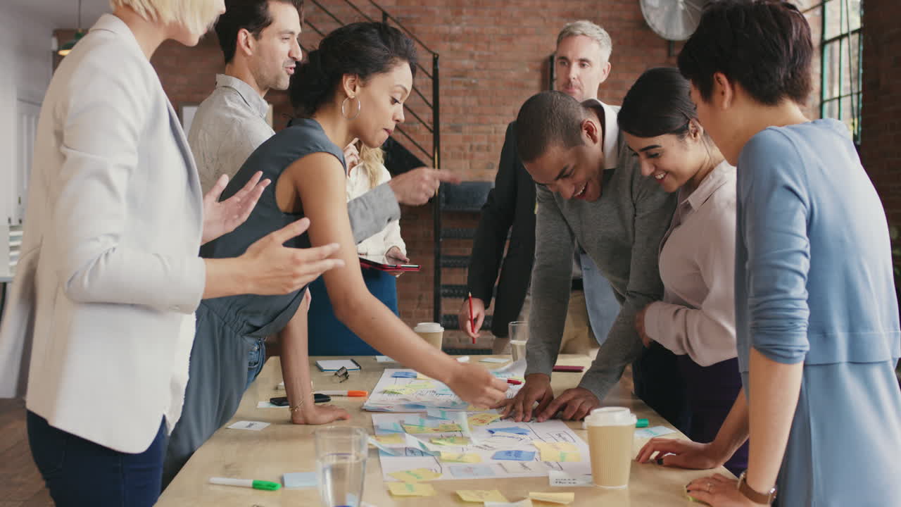 Steadicam shot in of creative diverse business team meeting