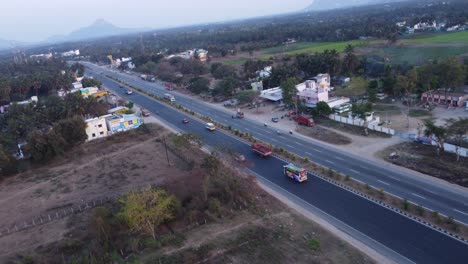 dynamic fpv aerial view of mumbai pune bangalore highway at sunset near davangere in karnataka, india