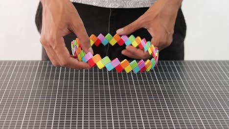 Hands-holding-and-showing-a-rainbow-origami-paper-crown