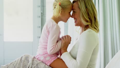 mother and daughter having fun in the bedroom 4k