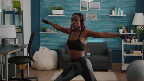 athletic woman with black skin warming up before aerobic class