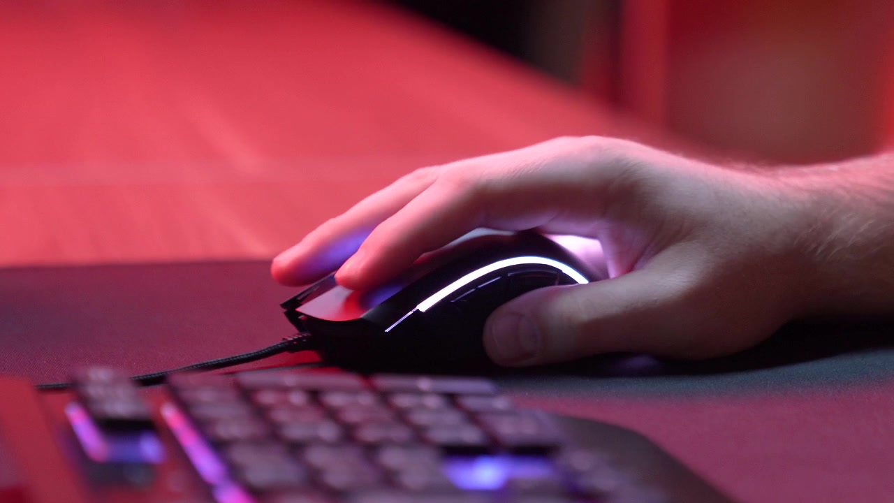 Close-up of Hand Clicking and Moving a Gaming Mouse with RGB Lighting